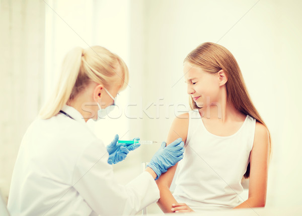 doctor doing vaccine to child in hospital Stock photo © dolgachov