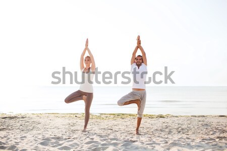 couple making yoga exercises outdoors Stock photo © dolgachov
