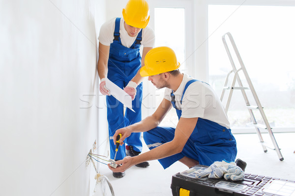 builders with tablet pc and equipment indoors Stock photo © dolgachov