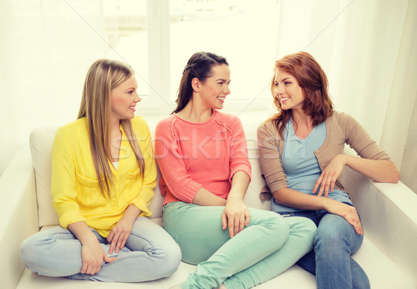 three girlfriends having a talk at home Stock photo © dolgachov