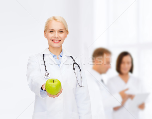 Foto stock: Sonriendo · femenino · médico · verde · manzana · salud