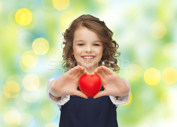 Mosolyog kislány piros szív szeretet jótékonyság Stock fotó © dolgachov