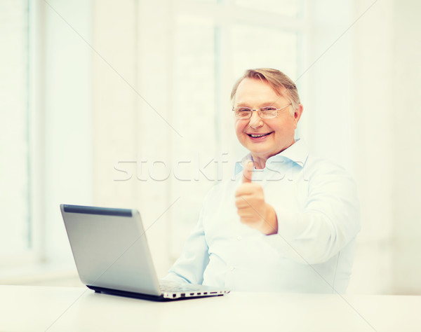 old man with laptop computer showing thumbs up Stock photo © dolgachov