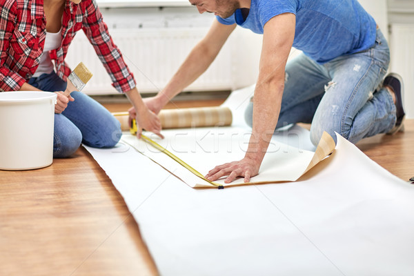 close up of couple measuring wallpaper Stock photo © dolgachov