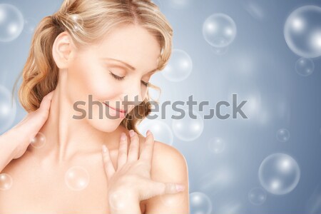 beautiful young woman face over blue background Stock photo © dolgachov