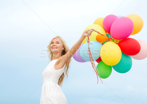 smiling woman with colorful balloons outside Stock photo © dolgachov
