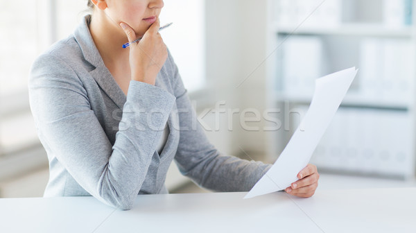 close up of woman reading papers or tax report Stock photo © dolgachov