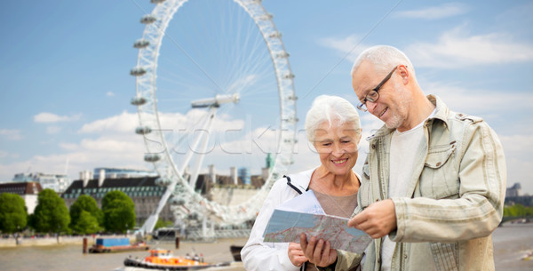 senior couple with map over london eye Stock photo © dolgachov