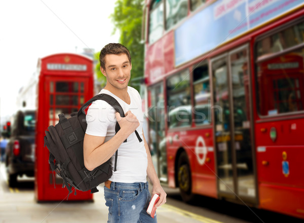 Stock photo: happy young man with backpack and book travelling