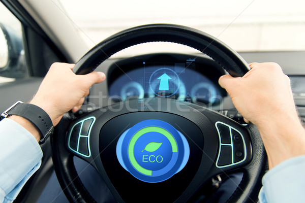 close up of young man driving car in eco mode Stock photo © dolgachov