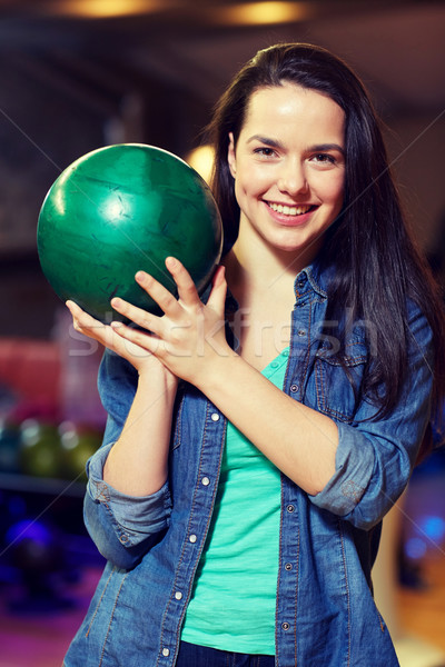 happy young woman holding ball in bowling club Stock photo © dolgachov