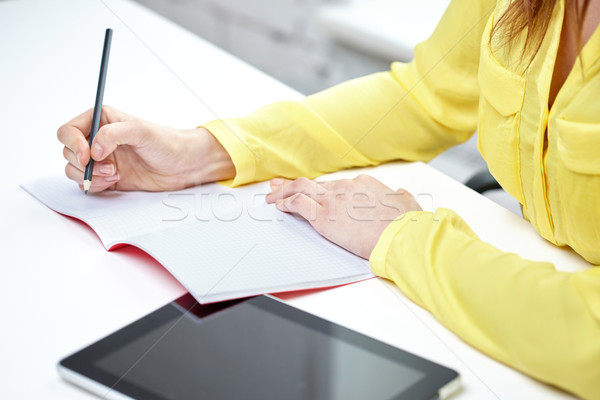 close up of woman with tablet pc and notebook Stock photo © dolgachov