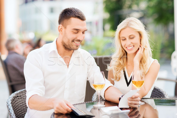 happy couple with wallet and bill at restaurant Stock photo © dolgachov
