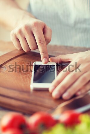 close up of man with smartphone making blood test Stock photo © dolgachov