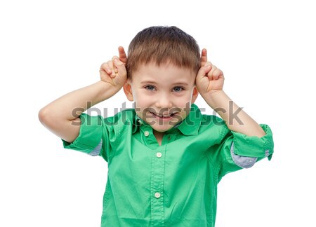 happy little boy having fun and making horns Stock photo © dolgachov