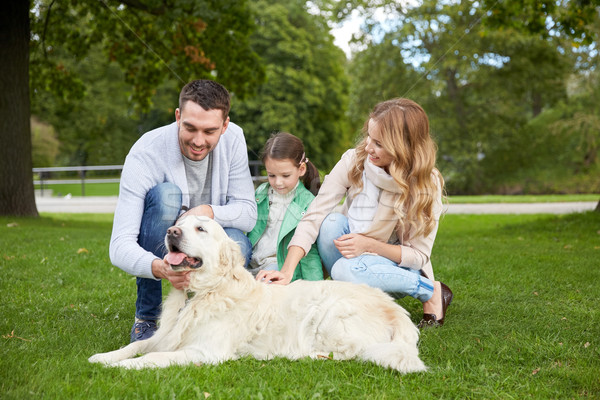 Stock photo: happy family with labrador retriever dog in park