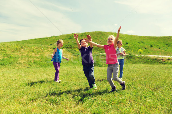 group of happy kids running outdoors Stock photo © dolgachov