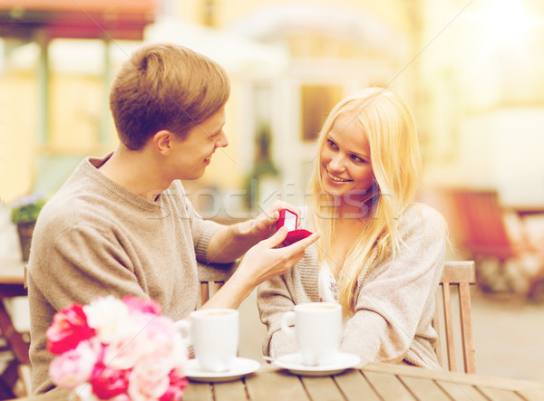 Stock photo: romantic man proposing to beautiful woman