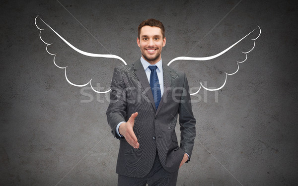 happy businessman with angel wings over gray Stock photo © dolgachov