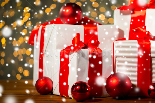 Stock photo: gift boxes and red balls on wooden floor