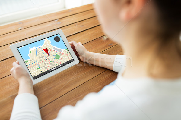 close up of woman with gps navigator on tablet pc Stock photo © dolgachov