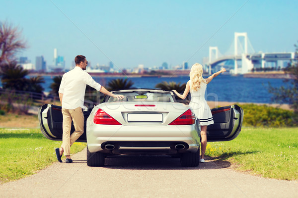 happy man and woman near cabriolet car in tokyo Stock photo © dolgachov