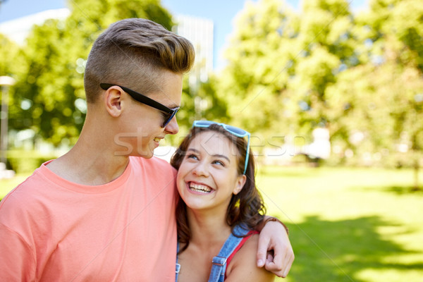 happy teenage couple looking at each other in park Stock photo © dolgachov