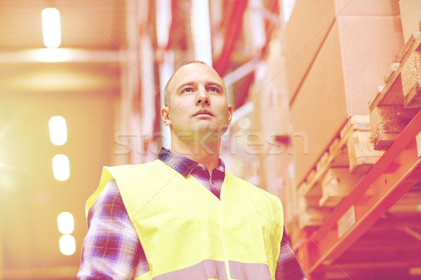 man in reflective safety vest at warehouse Stock photo © dolgachov