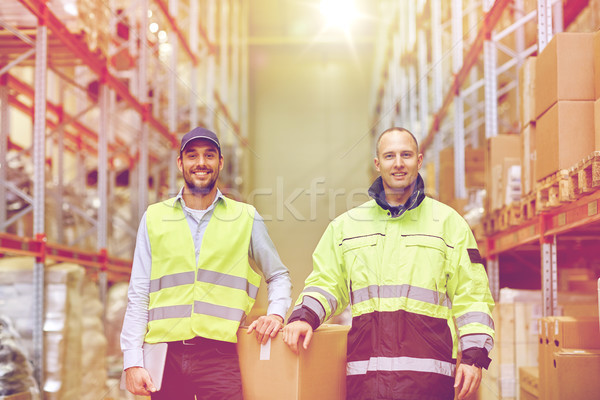 men in uniform with boxes at warehouse Stock photo © dolgachov