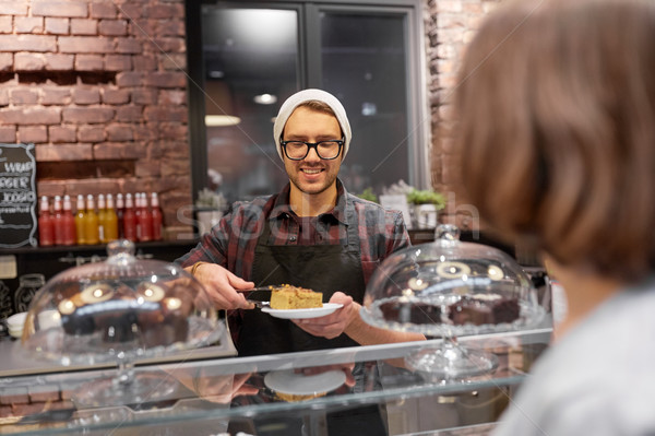 man or barman with cake serving customer at cafe Stock photo © dolgachov
