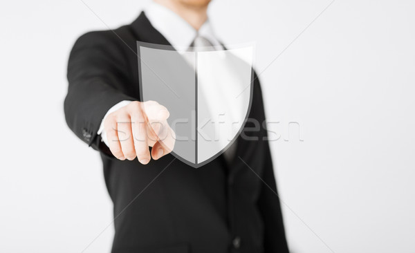 man pointing finger at antivirus program icon Stock photo © dolgachov