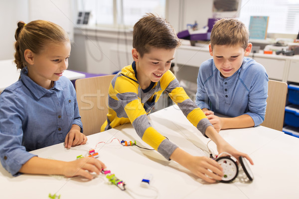 happy children building robots at robotics school Stock photo © dolgachov