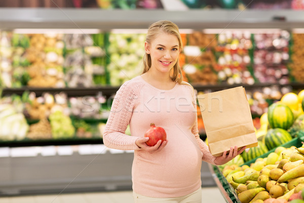 pregnant woman with bag buying fruits at grocery Stock photo © dolgachov