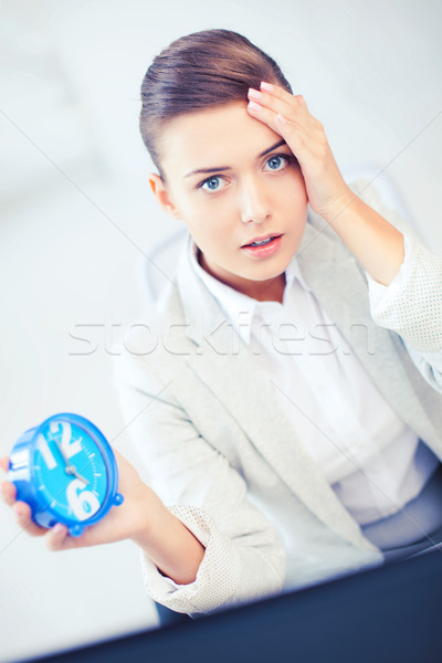 stressed businesswoman holding clock Stock photo © dolgachov