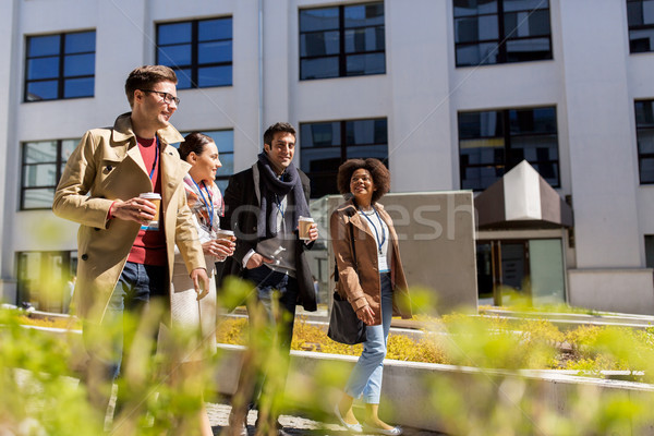 Stock photo: people with coffee and conference badges in city