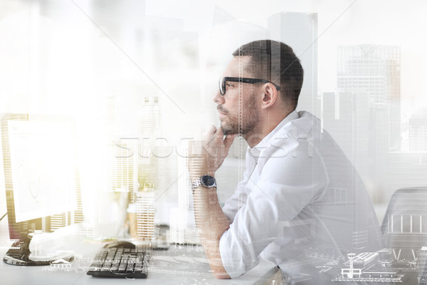 businessman in glasses sitting at office computer Stock photo © dolgachov