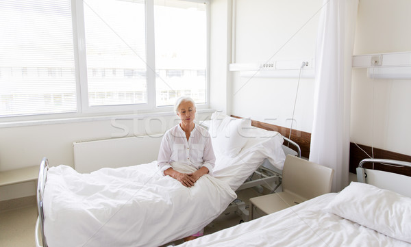 sad senior woman sitting on bed at hospital ward Stock photo © dolgachov