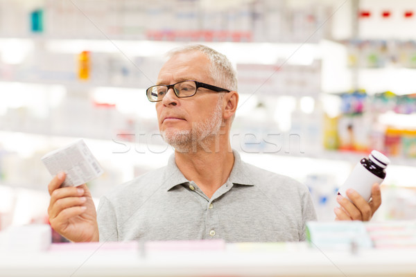 senior male customer choosing drugs at pharmacy Stock photo © dolgachov