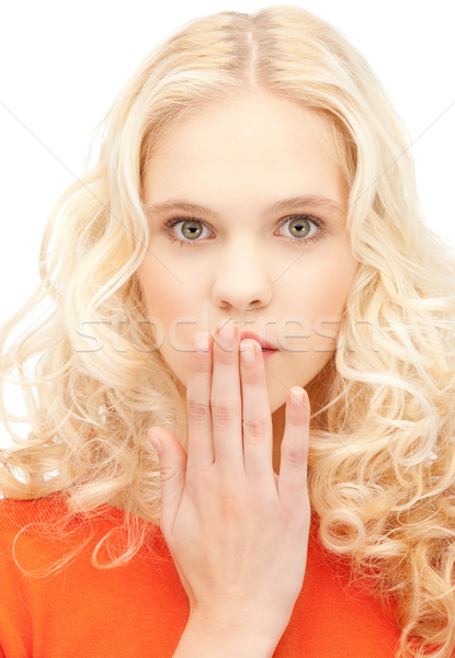 teenage girl with palms over mouth Stock photo © dolgachov