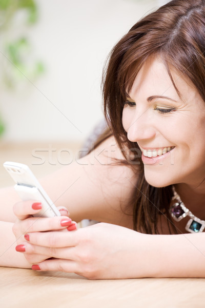 woman with white phone Stock photo © dolgachov