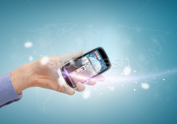 hand showing smartphone with news app Stock photo © dolgachov