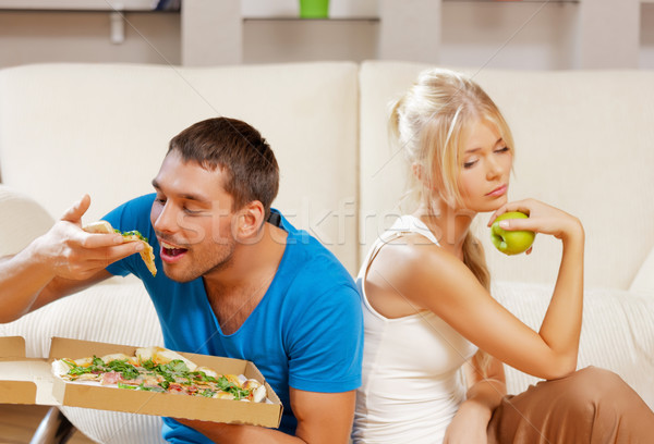 couple eating different food Stock photo © dolgachov