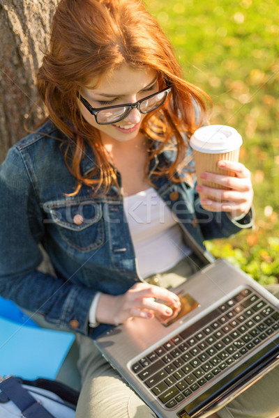 Stock photo: teenager in eyeglasses with laptop and coffee