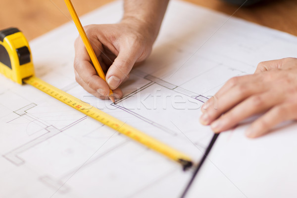 close up of male hands making changes to blueprint Stock photo © dolgachov