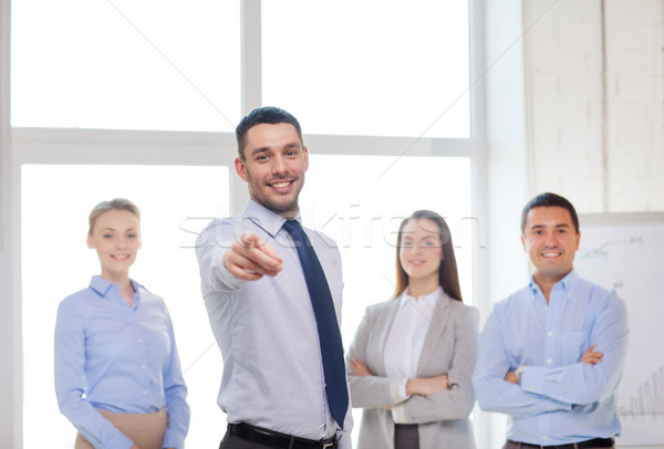 Stock photo: businessman in office pointing finger at you
