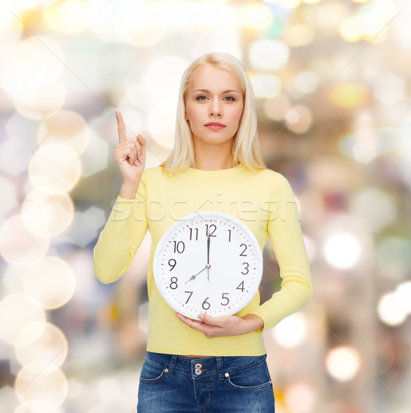 student with wall clock and finger up Stock photo © dolgachov