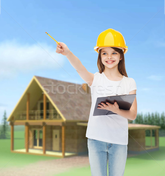 smiling little girl in hardhat with clipboard Stock photo © dolgachov