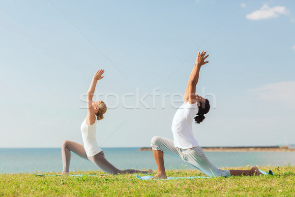 Gülen çift yoga açık havada uygunluk Stok fotoğraf © dolgachov