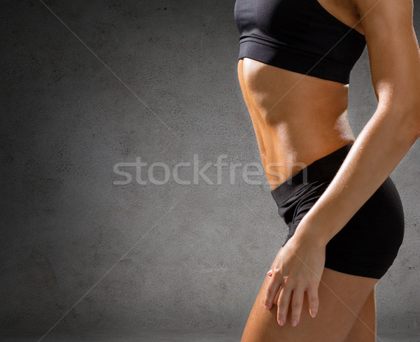 close up of athletic female abs in sportswear Stock photo © dolgachov