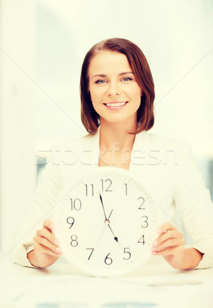 attractive businesswoman with white clock Stock photo © dolgachov